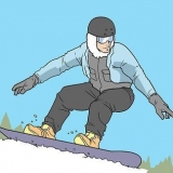 Fazendo um frontside 360 ​​em uma prancha de snowboard